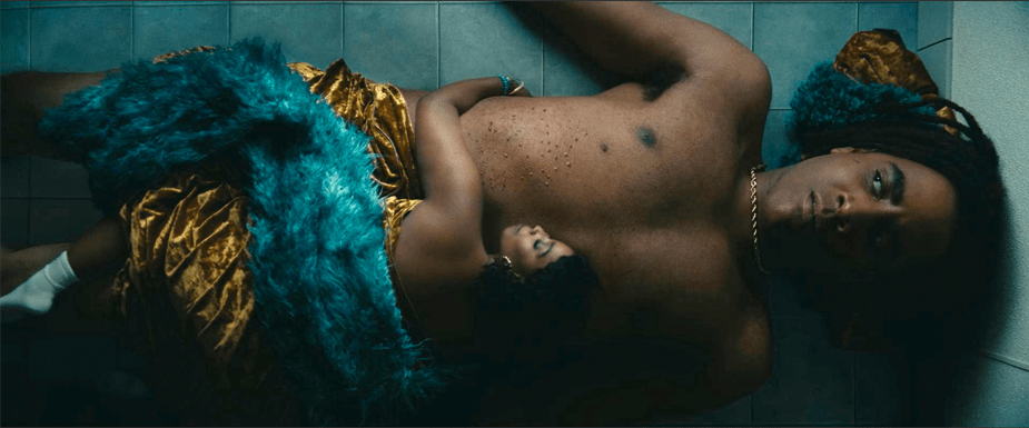 13-ft-tall black man lying on his back being cuddled by a normal-size black woman